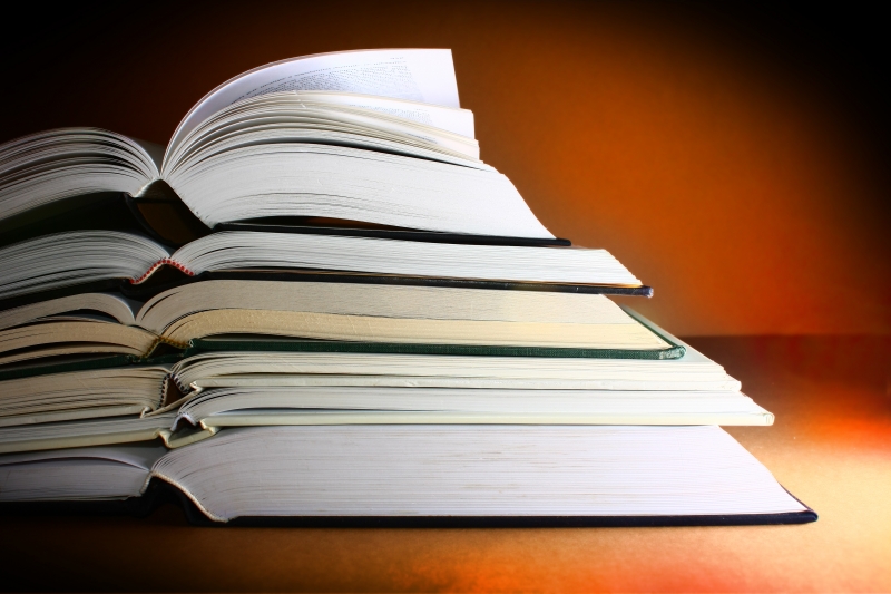 484391-pile-of-books-against-a-warm-background